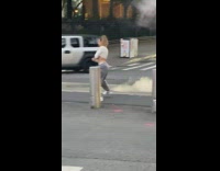 Girl grey pants dance middle street steam