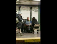 man and woman playing connect 4 at station