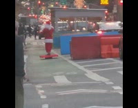 Santa rides electric red platform down street 