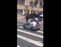 Four kids ride small cybertruck on street