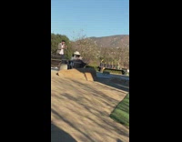 Woman white hat sit  chair large rock