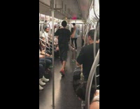 a man in a black shirt jumping and swinging from train