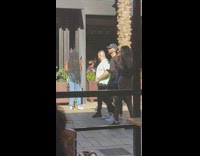 Woman black floral dress lean tree street