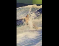 Man shirtless indoor surf then fell from board