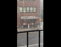 People take shelter on street during rain