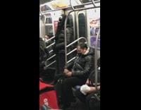 Guy wears black costume mask on subway 