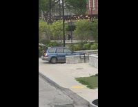 Man in black top tiktok dance at the park