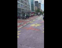 Guy on crosswalk operates remote control car on street