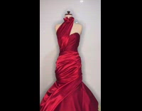 Guy creates designs red dress on mannequin 