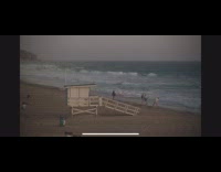 Man dances with camera crew at beach