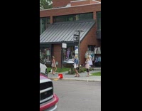 Brown dress girl sidewalk clothing store cone 