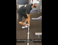 Guy does deadlifts with feet facing opposite ways