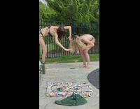 Two girls bikini look ground play hair