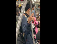 Collab WINY - Man with Baby Doll Uses Phone in Subway