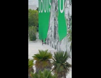 Two women black bikini boots green Louis Vuitton Wall