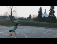 Guy handstand then shoot ball inside hoop
