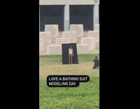 Woman bathing suit black backdrop white stones