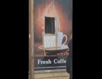 Hole in window with we are open sign