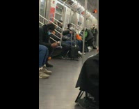 Lady wearing black vest dances on subway