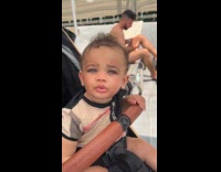 Baby in seat stares with beautiful eyes