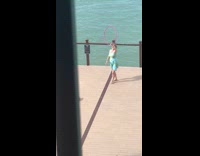 Woman dress spin hula hoop tricks beach part 1