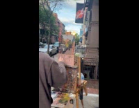 Man gray hoodie paint the street sidewalk