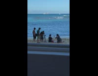 Two girls sitting in yoga position on beach