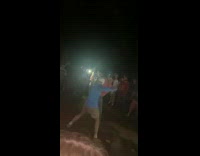 Two guys fight in middle of crowd