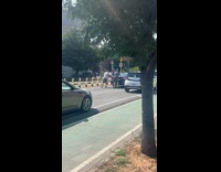 Men help push car on the street 