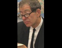 Man wears two glasses in front of each other to wear newspaper on the subway