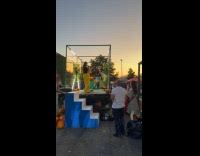 Crowd cheers woman smash pumpkin at street