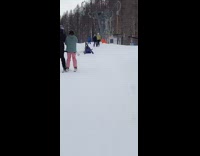Guy zooms in on skiier sitting ground