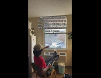 Guy rocking chair looking out window 