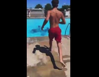 Group of people in the pool sitting on lawn chairs 