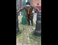 Scary clown mask guy push ups outside 