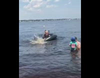 Woman climbs out of inflatable bull ride and falls into water