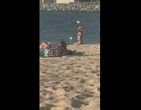 Woman patterned bikini tripod timer daughter beach