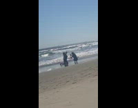 Girl swimsuit kneel sand hold head beach