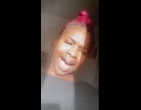 Black shirt girl stands by sunny window 