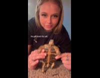 Woman holds standing turtle dance to music