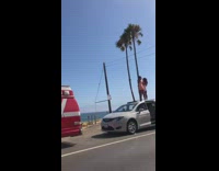 Two girls dance white minivan car roof