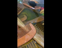 Wooden combs inside container filled with oil