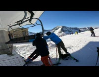 Skier stuck on ski lift with pants tangled on lift