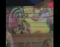 Woman selfie video drink graffiti wall party