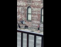 Girl black dress flash umbrella brick building