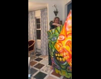 Woman shows artwork with two canvas combined