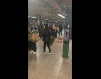 Guy dances to band while another is getting arrested 