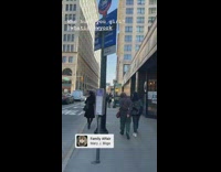 Girl walking down sidewalk carries wood bat 