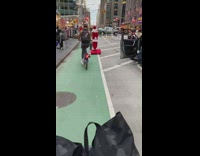 Guy wearing santa costume rides red platform