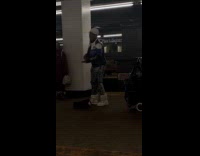 Woman wears jacket sings at subway platform